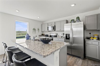 Kitchen with dark wood-type flooring, gray cabinet