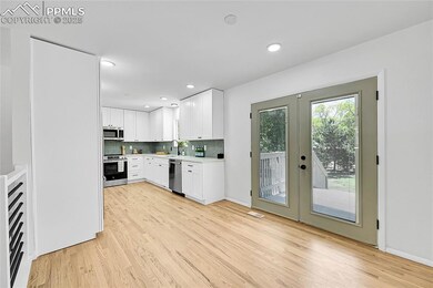 Dining area looking into the backyard and Kitchen. Featuring French Doors