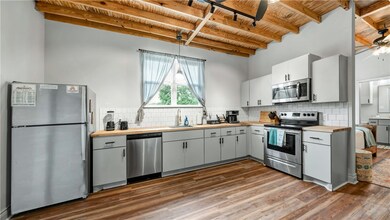 Kitchen with stainless steel appliances, a sink, w