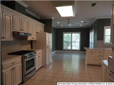 The spacious kitchen has ceramic tile floors and h