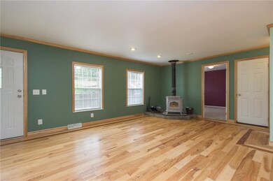 Living room with hickory wood floors and wood burn
