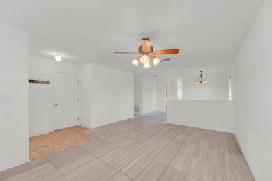 Spare room featuring light tile patterned floorin