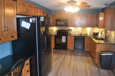 Kitchen with surplus of cabinets, granite counters and vinyl plank flooring.  All Appliances stay!