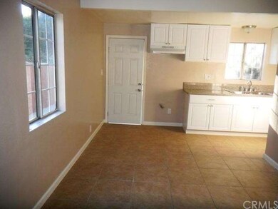 In dining area, door to backyard ahead, kitchen on