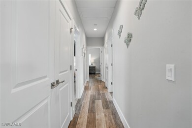 Hall featuring wood finished floors and baseboards