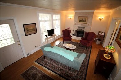 The living room has a fireplace and french doors t