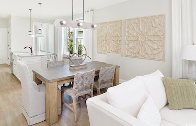 Dining room with ornamental molding and light wood finished floors