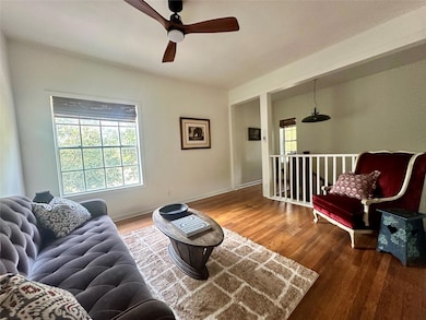 Living room featuring wood finished floors and ceiling fan
