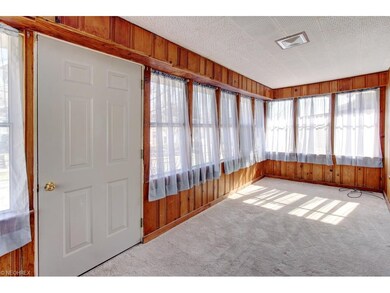 Enclosed front porch with tons of natural light.