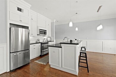 Spacious and modern kitchen with white cabinetry,