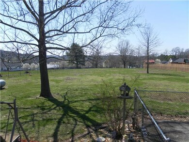 View of the Fenced Back Yard from the Screened Porch