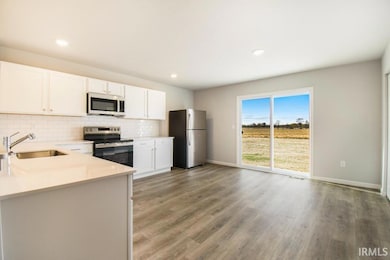 The great room flows into the kitchen, separated b