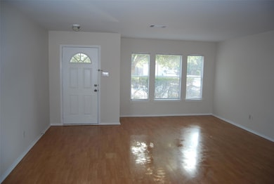 Entryway featuring baseboards, wood finished floo