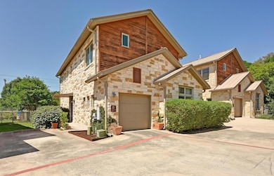 View of front of house with driveway, fence, and 