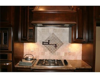 Kitchen. Tumbled marble backsplash with hot water spigot. Perfect for pasta night!