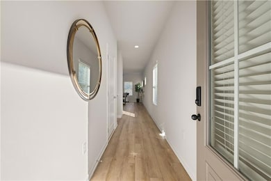 Hallway with recessed lighting, light wood-type fl