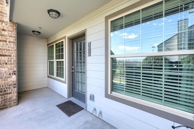 View of exterior entry featuring covered porch