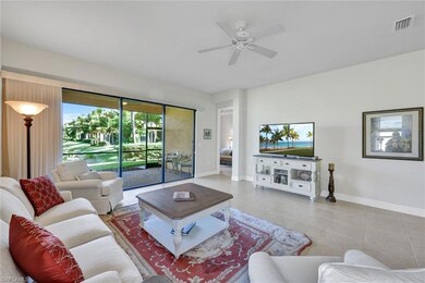 Tiled living room featuring ceiling fan