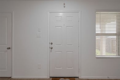 Step inside to a bright and airy entryway that imm