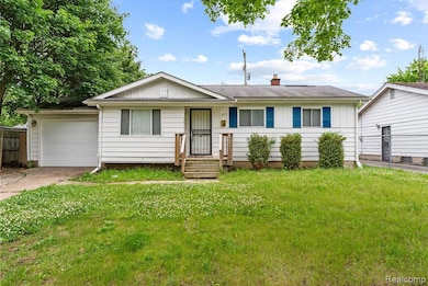 Ranch-style home featuring board and batten siding, a chimney, and driveway