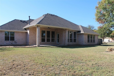 Back of house with large yard