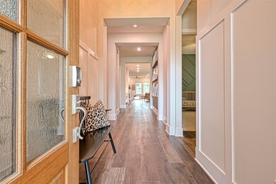 Rain glass front door opens to the latest high-end, luxury vinyl plank flooring both waterproof and furry kid proof easy to maintain and 100% gorgeous. Soaring 15' entryway ceilings. The blunt straight archways are the new modern contemporary version and look super fabulous with tall wainscoting wall detail & tall baseboards.