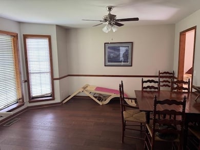 Dining space with ceiling fan and wood finished floors
