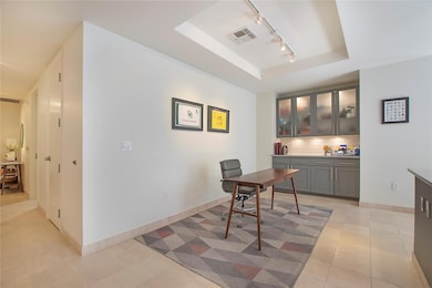 Built-in coffee bar adjacent to kitchen with plent