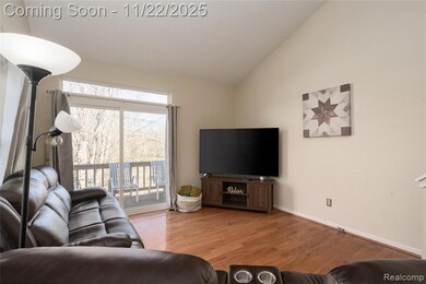 Living area featuring vaulted ceiling and wood finished floors