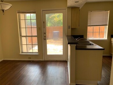 Dining space leads out to fenced in yard