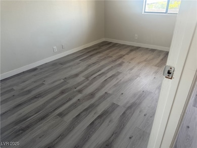 Empty room with baseboards and wood finished floor