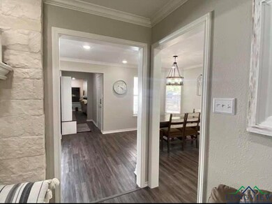 Hallway featuring baseboards, wood finished floors