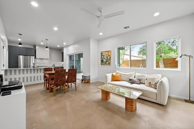 Living room with baseboards, finished concrete fl