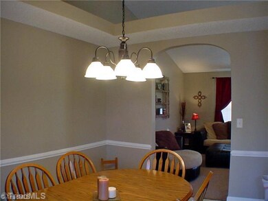 Dining Room. Another view of the dining area as it connects to the living room.  Notice the details of chair rail, plant shelf, and arched doorway.  And there s plenty of space for a corner hutch.