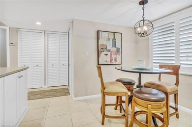 Dining area with light tile patterned flooring, baseboards, a notable chandelier, and recessed lighting