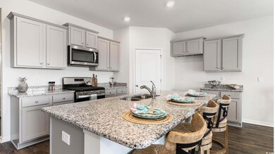 Kitchen featuring a breakfast bar area, dark wood-