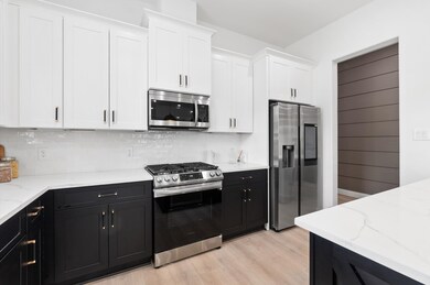 View of two-tone custom cabinetry and doorway lead