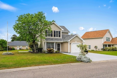 Traditional home featuring a garage, a front yard,