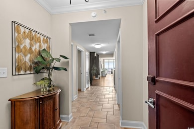 Corridor featuring crown molding and baseboards
