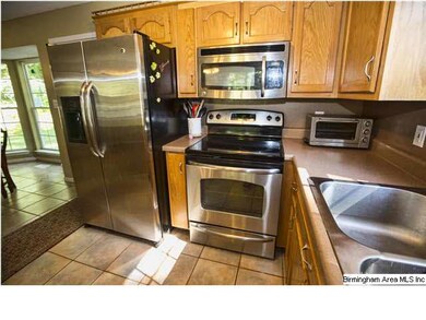Kitchen with stainless appliances, tile floor and 