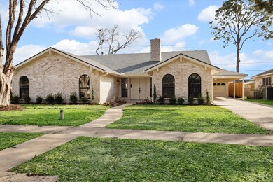 Stunning front view with lush landscaping and a Ge