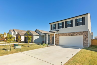 View of front of home featuring concrete driveway, brick siding, and an attached garage