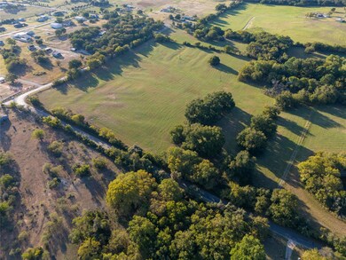 Birds eye view of property featuring a rural view
