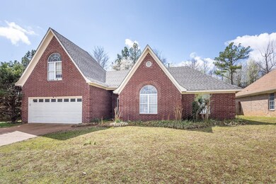 Traditional home with brick siding, an attached ga