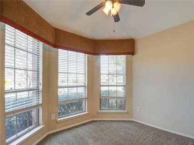 Spare room featuring healthy amount of natural light, carpet, and a ceiling fan