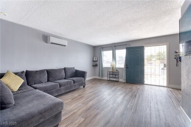 Living room featuring a textured ceiling, wood fin