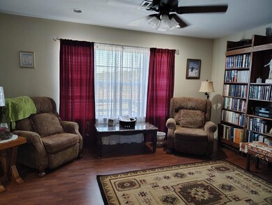 Sitting room with hardwood / wood-style flooring a