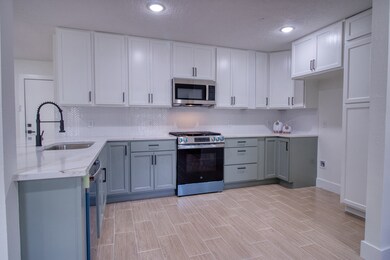 Two toned cabinets with new appliances