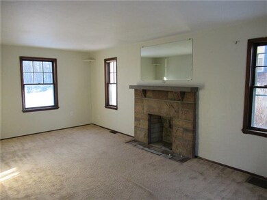 Living room freshly painted with stone fireplace