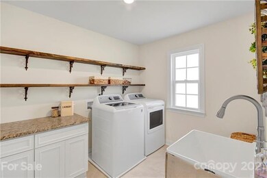 Large laundry on upper floor with sink